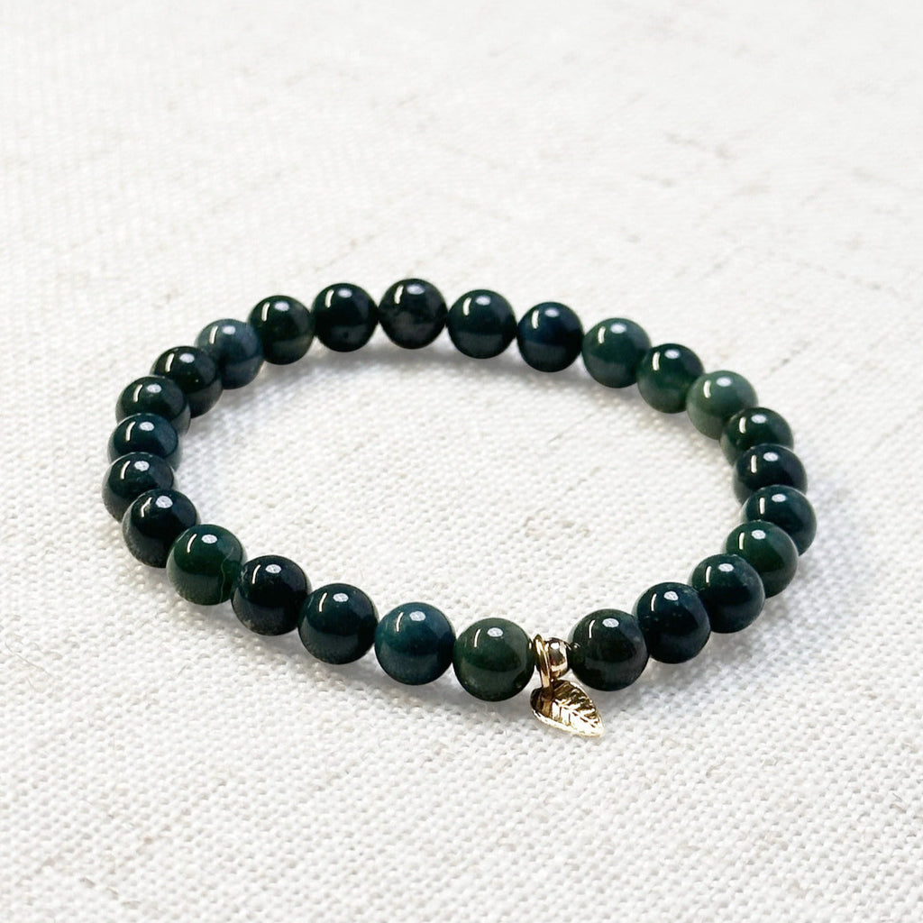 Earth-toned moss agate bracelet featuring leafy inclusions and golden detail