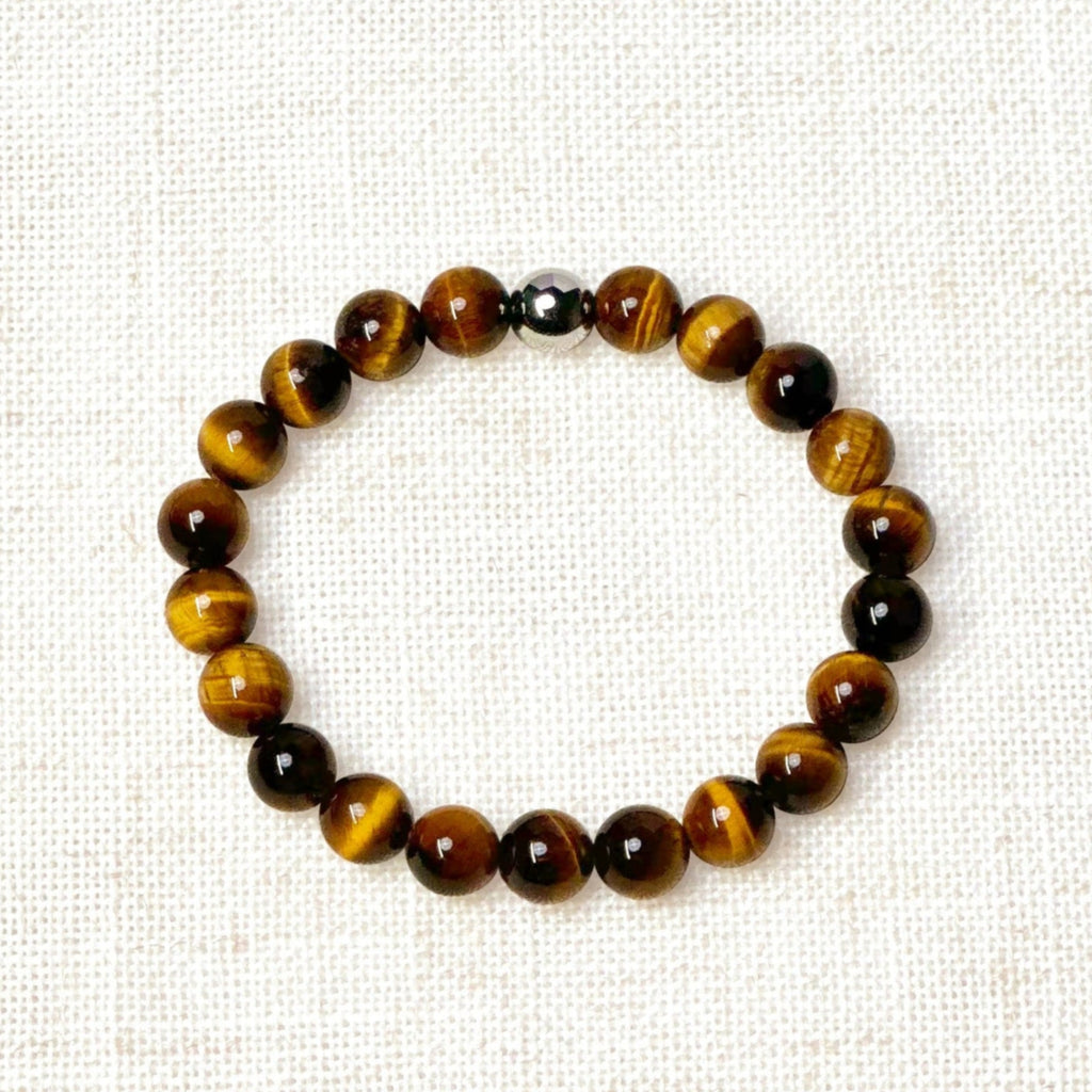 8mm yellow tiger’s eye bracelet with silver bead on neutral background