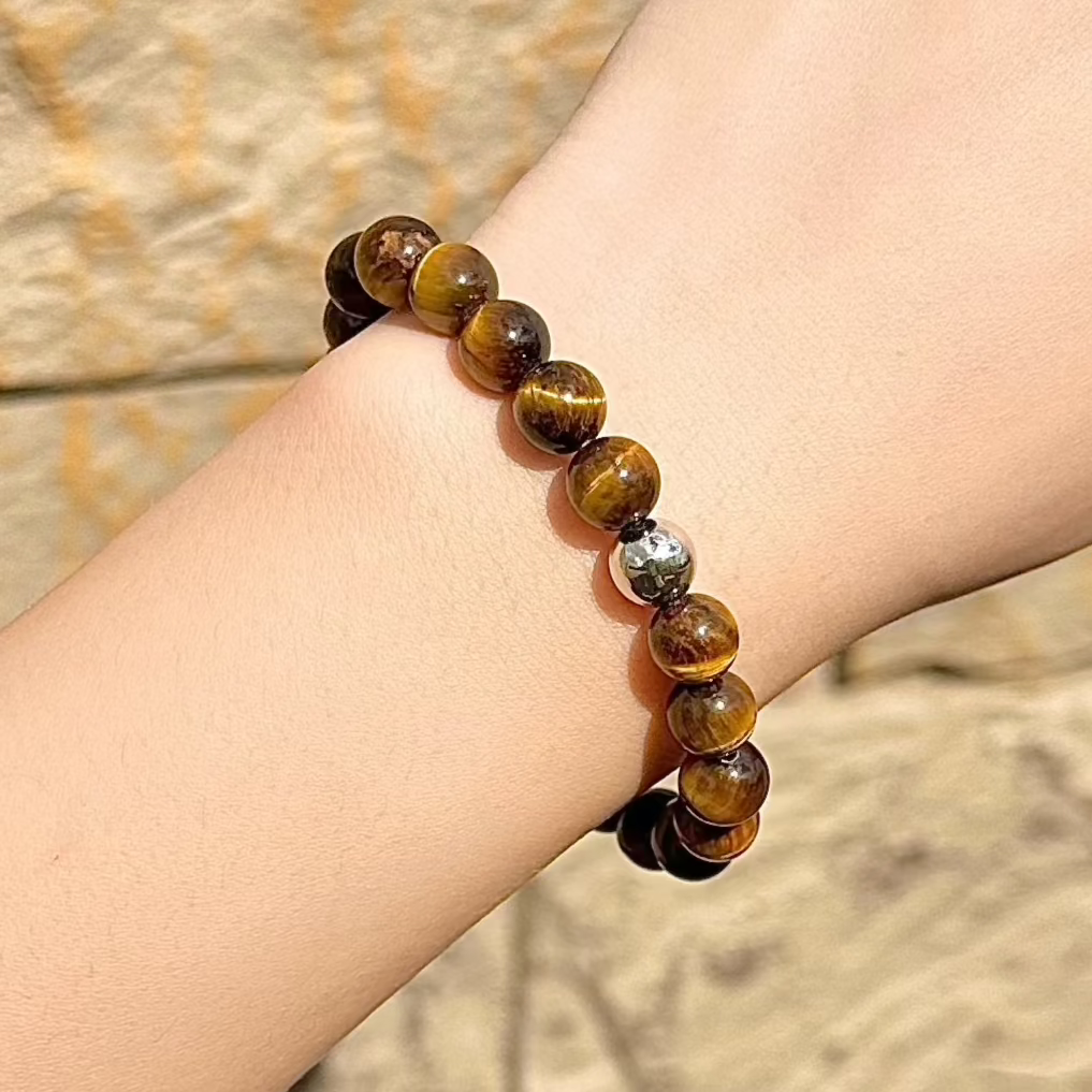 Yellow Tiger’s Eye crystal gemstone bracelet with warm golden hues, symbolizing confidence, strength, and protection.