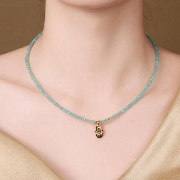 Soothing Amazonite crystal necklace with a protective evil eye pendant, designed to block negative energy.