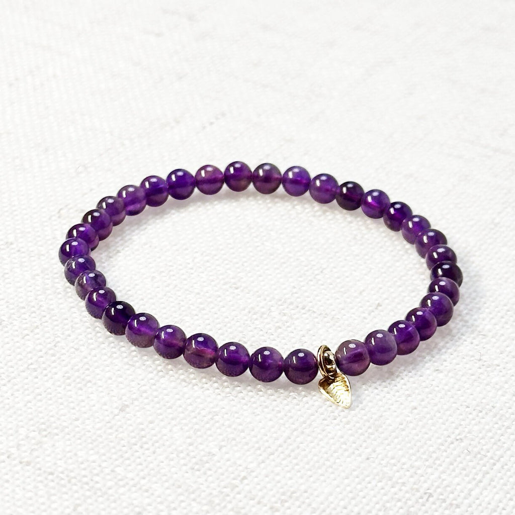 Natural Amethyst bracelet with deep purple crystal beads and golden leaf charm