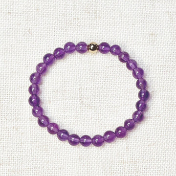 Amethyst bracelet with golden bead charm for emotional balance