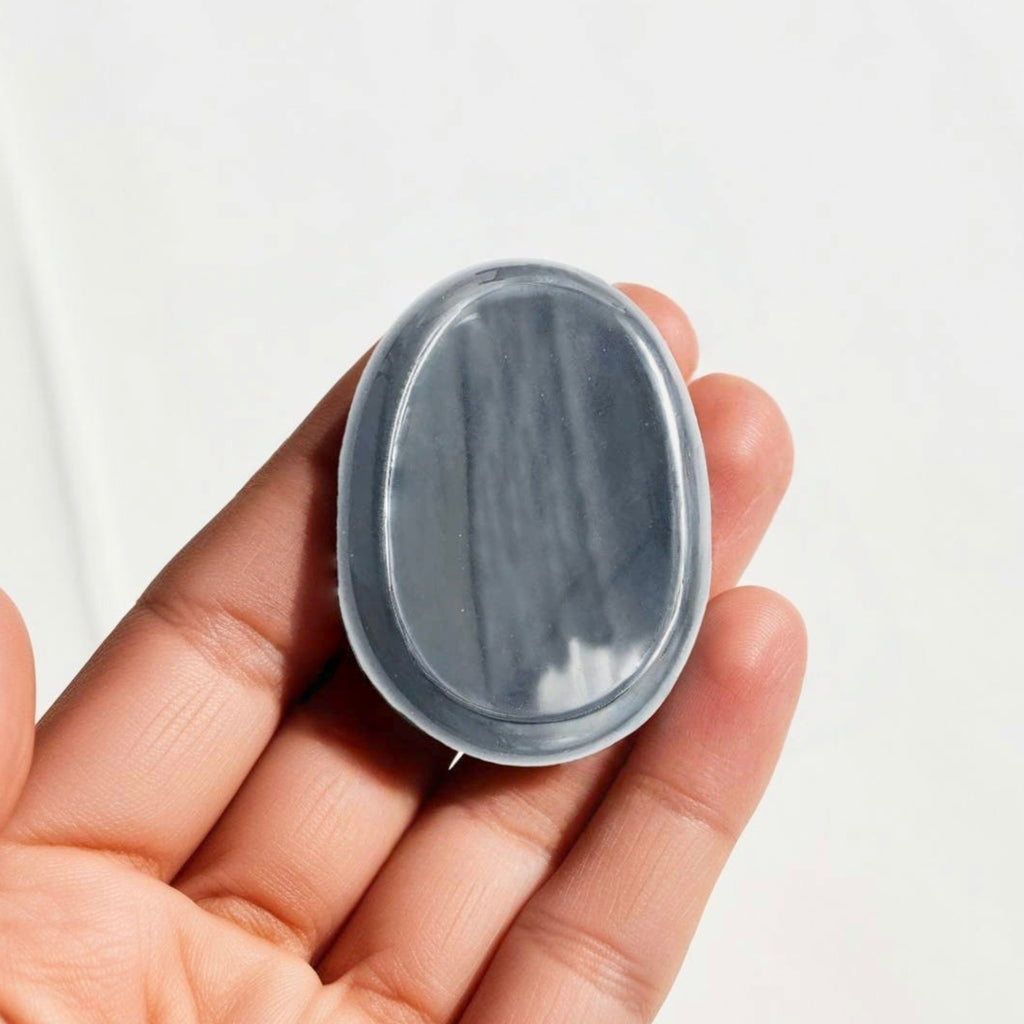 Polished Black Obsidian crystal worry stone in a thumb shape, promoting grounding, clarity, and energy shielding. Healing Properties, Black Stone.