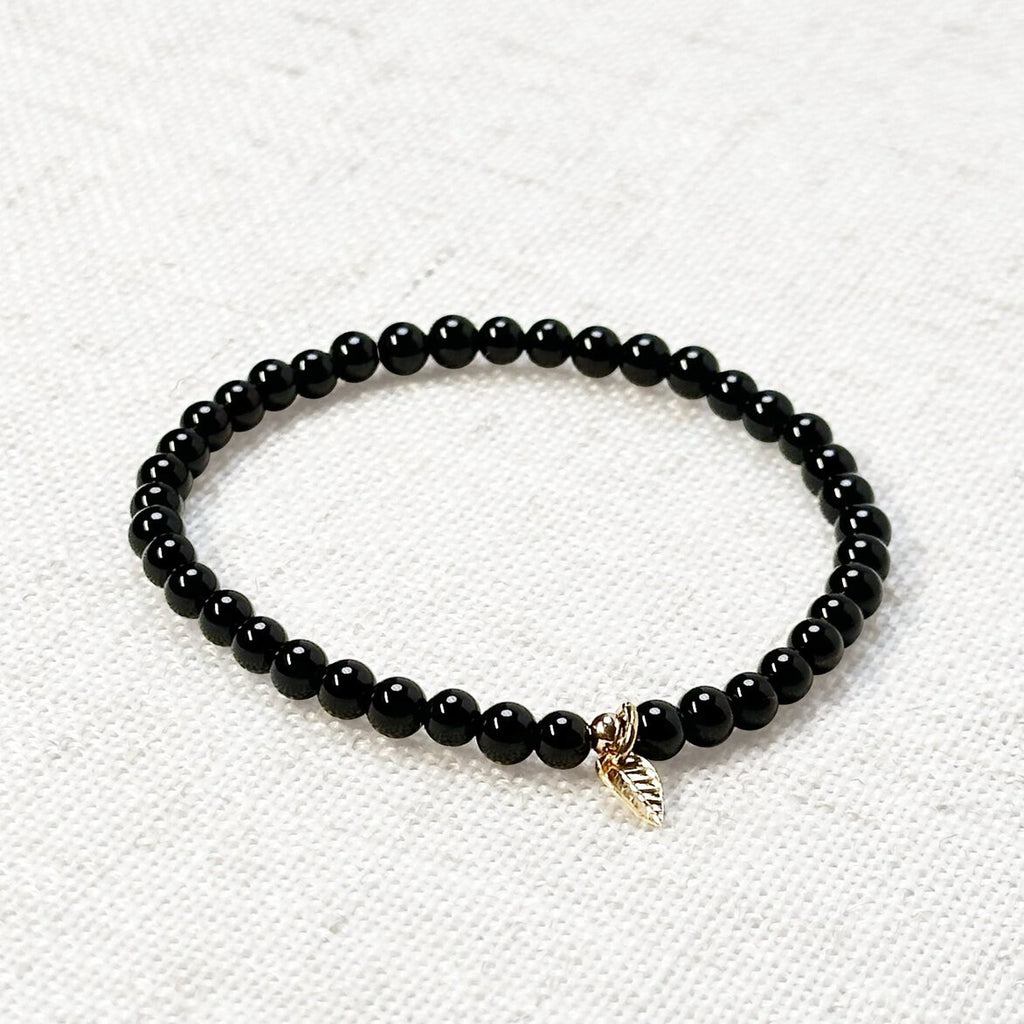 Black Onyx bracelet with 4mm polished beads and golden leaf charm