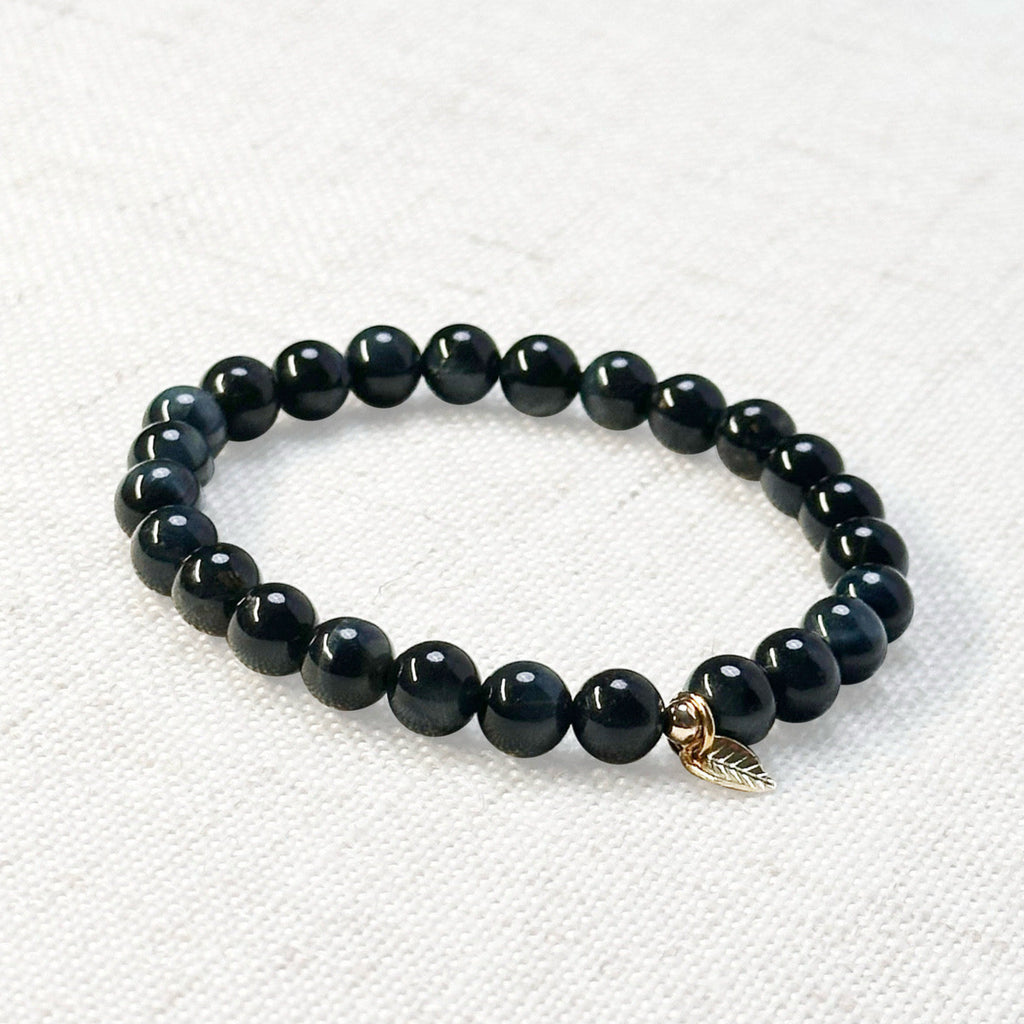 Tiger’s eye crystal bracelet in deep blue tones with gold accent