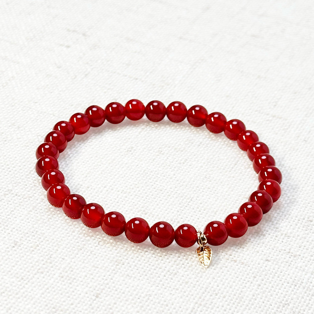 Close-up of polished Carnelian energy bracelet with fiery tones