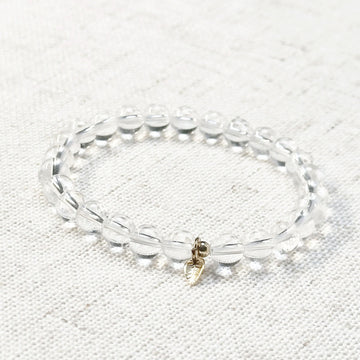 Clear quartz bracelet with 6mm transparent beads and golden leaf charm