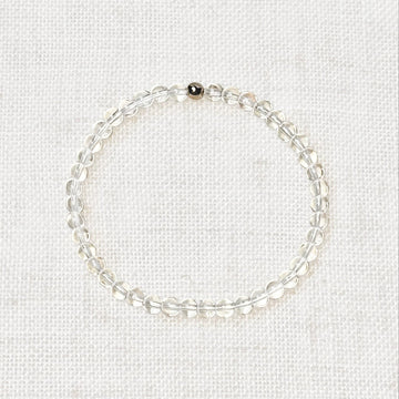 Clear quartz bracelet with 4mm polished beads and gold bead charm
