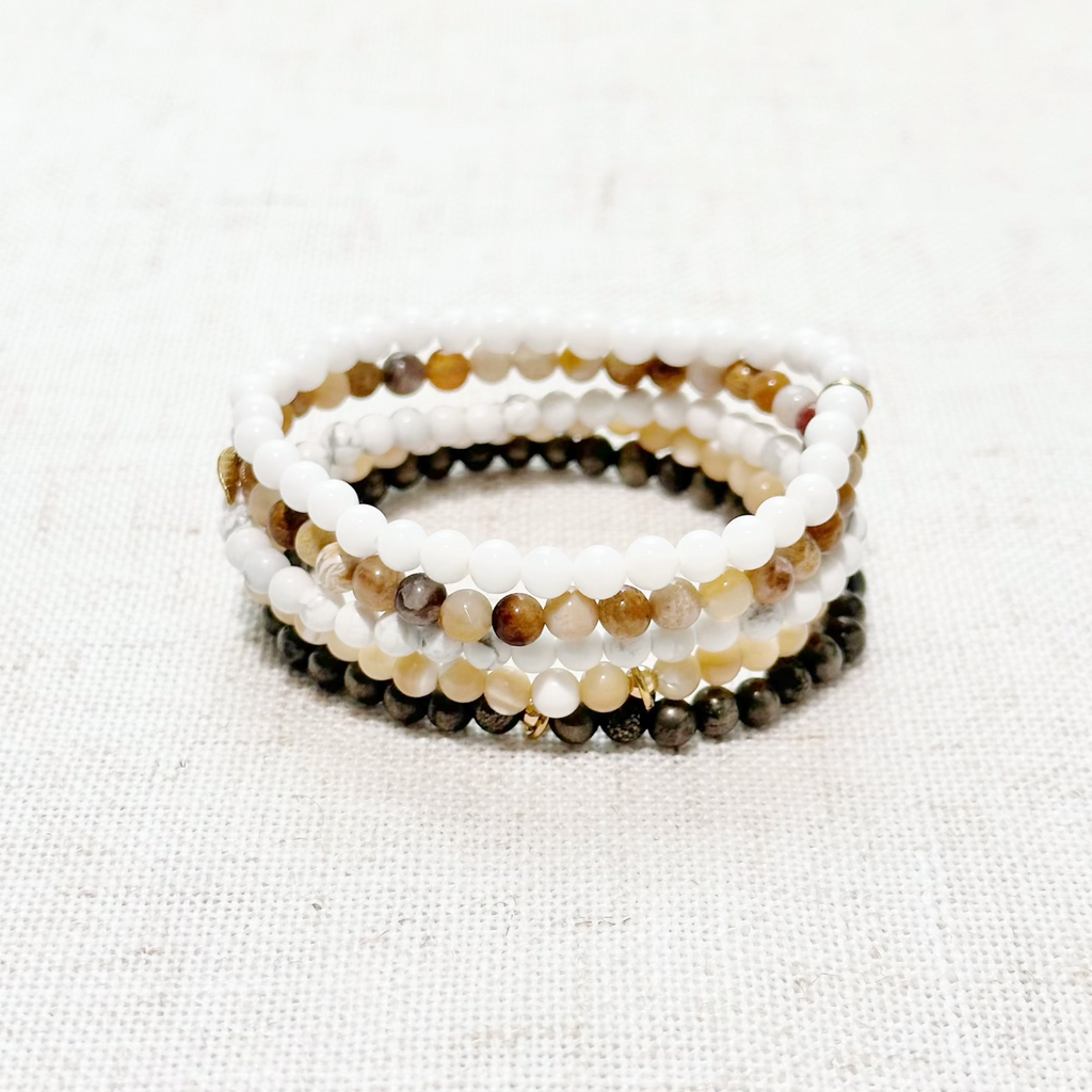 Coastal Calm & Power crystal bracelet set with Howlite, Coral Jade, Pyrite, Driftwood Shell, and White Shell beads.