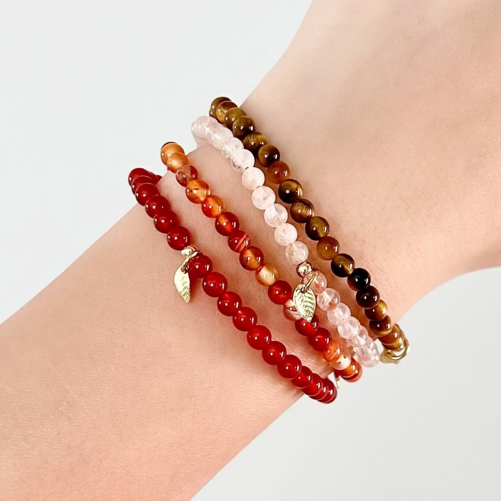 Stacked Leo crystal bracelets shown on wrist