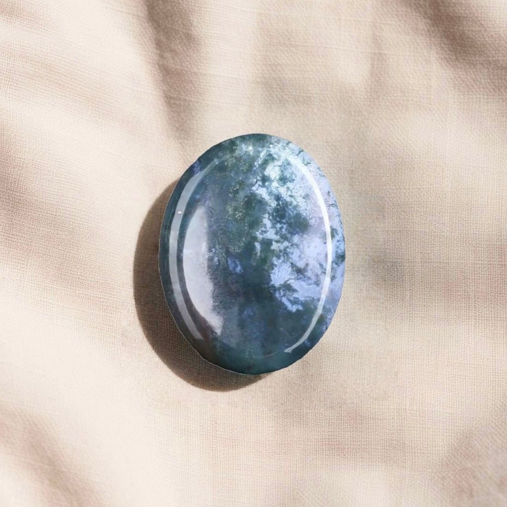 Thumb-shaped Moss Agate worry stone for stress relief, emotional balance, and grounding energy.
