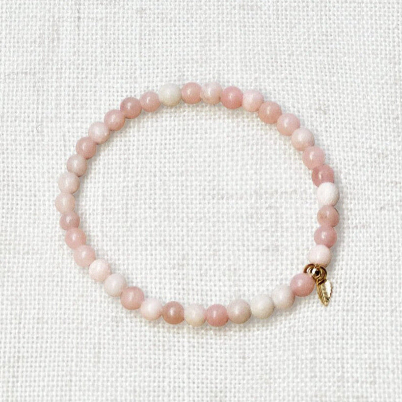 Close-up of 4mm pink opal bracelet with soft pastel tones and golden accent
