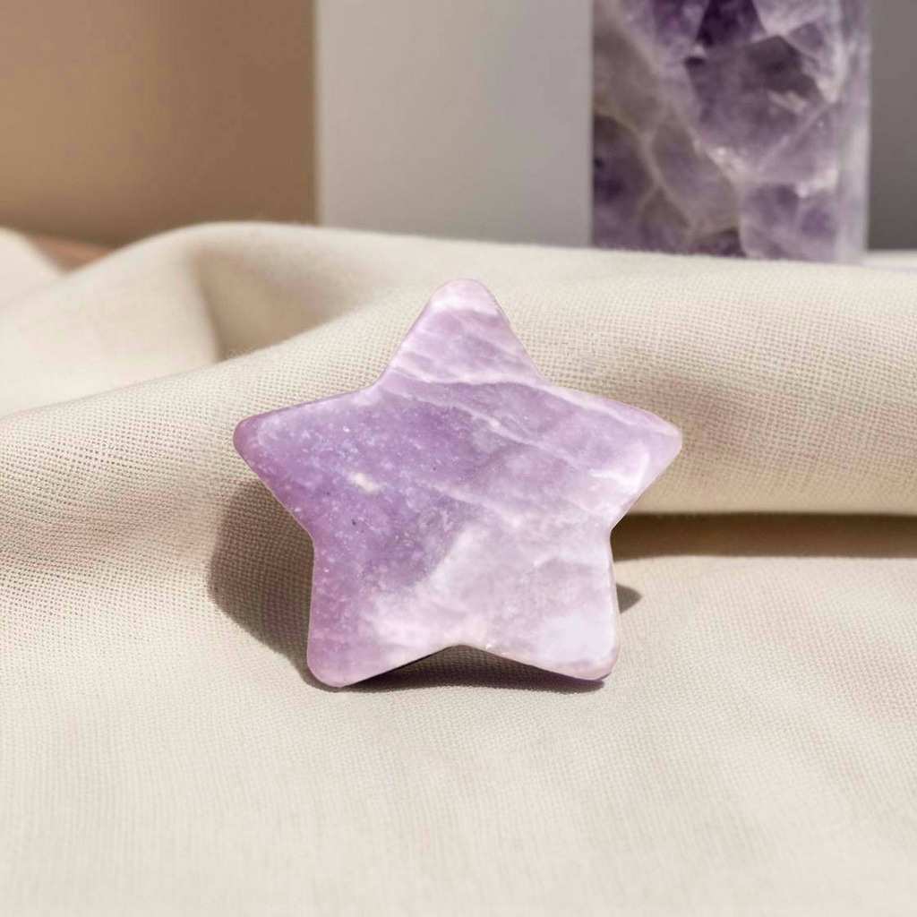 Polished Dream Amethyst crystal worry stone in a star shape, promoting intuition, relaxation, and balance.