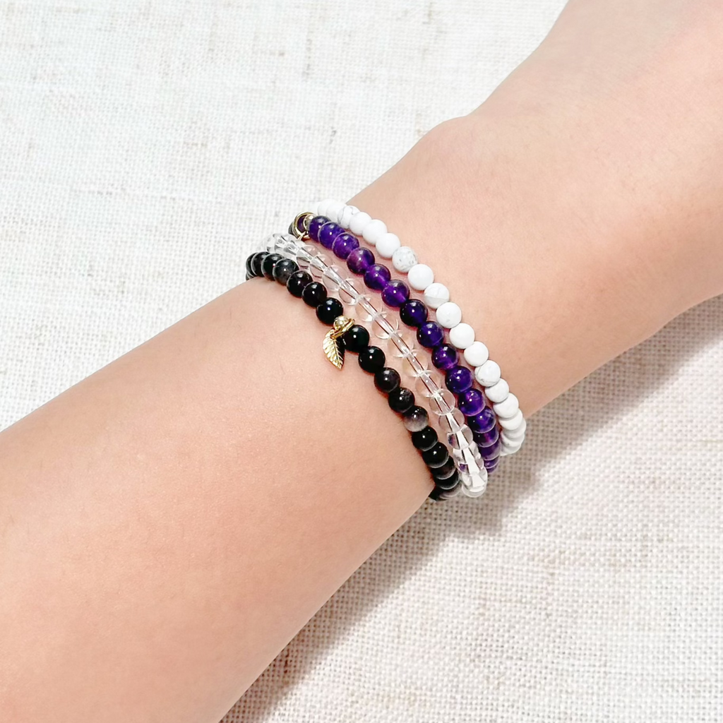 Close-up of protection-focused gemstone bracelets with polished natural stones.