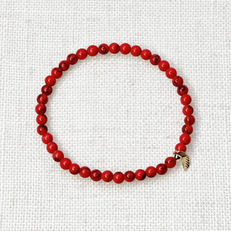 Red turquoise energy bracelet with golden charm for creativity