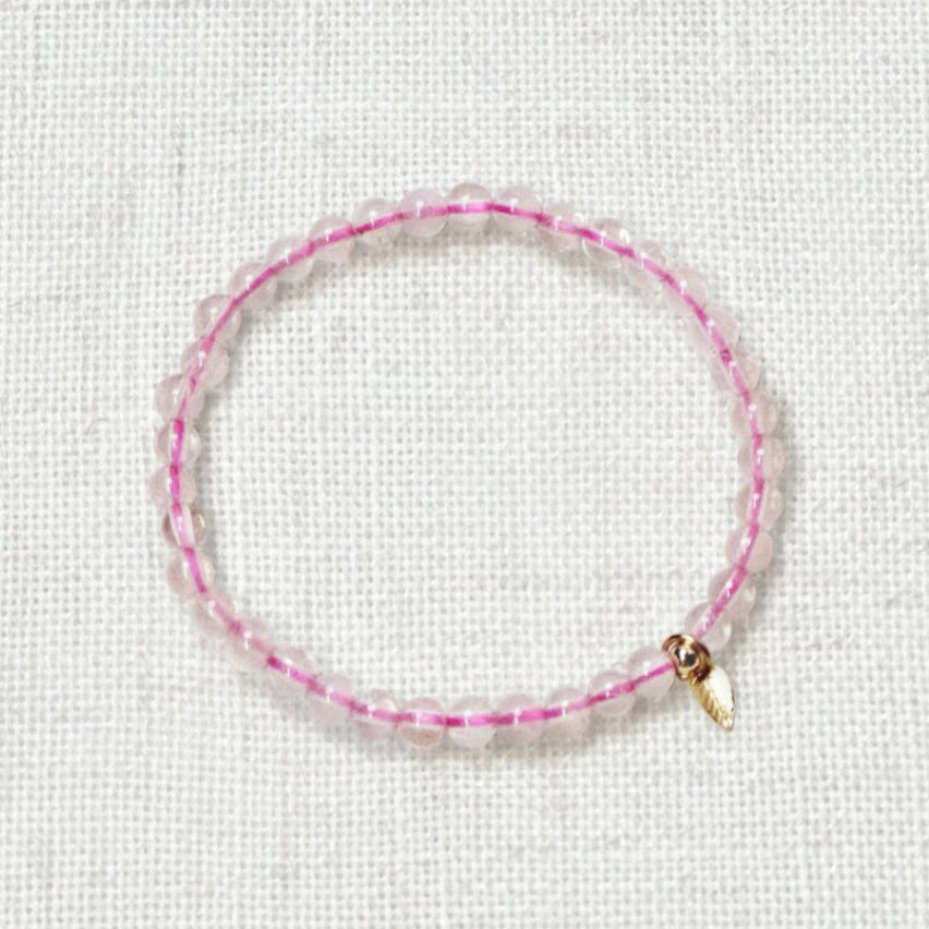 Soft pink rose quartz crystal bracelet symbolizing compassion and self-love