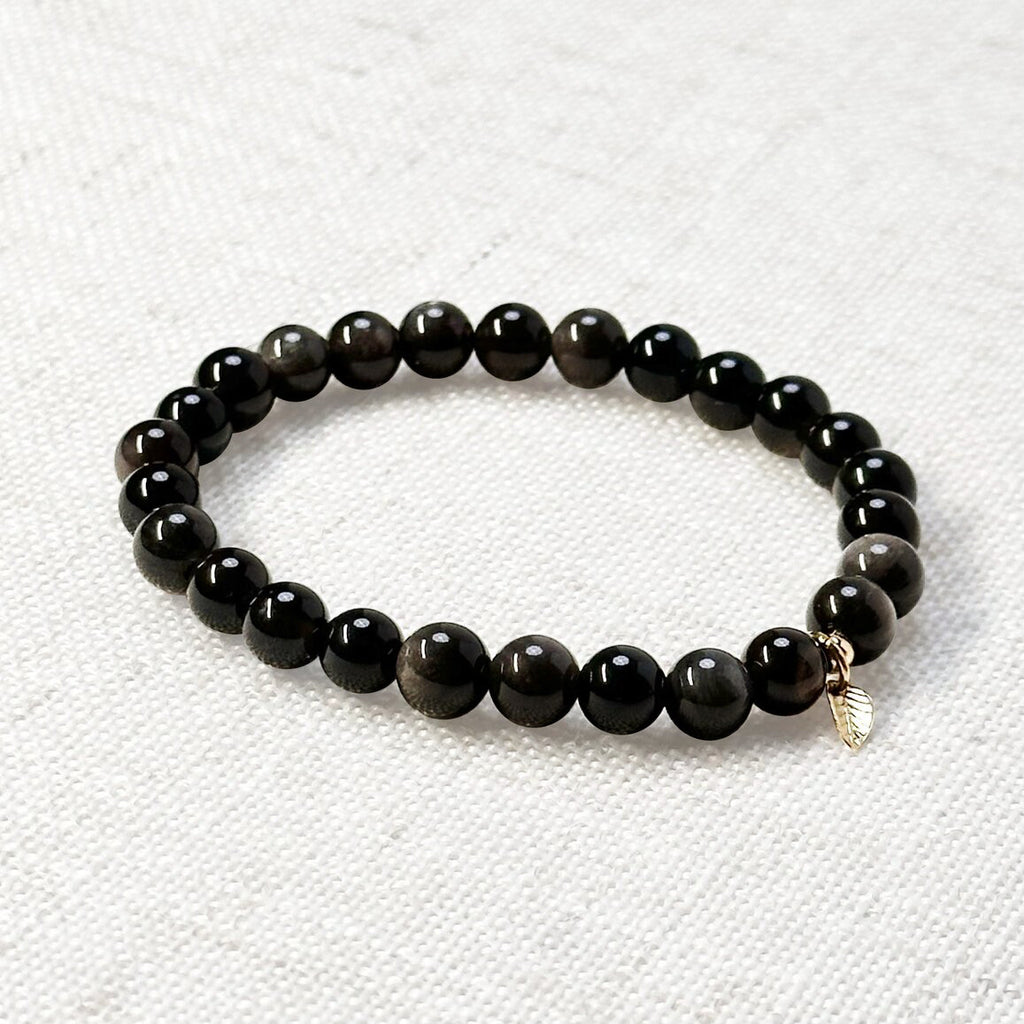 Silver obsidian bracelet with 6mm beads and golden leaf charm for grounding and clarity