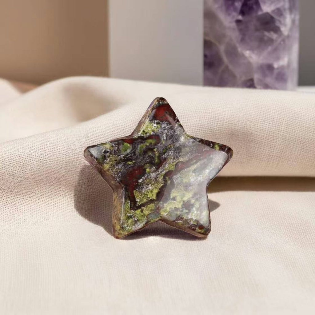 Star-shaped Dragon Blood Jasper worry stone for strength, stress relief, and emotional balance.