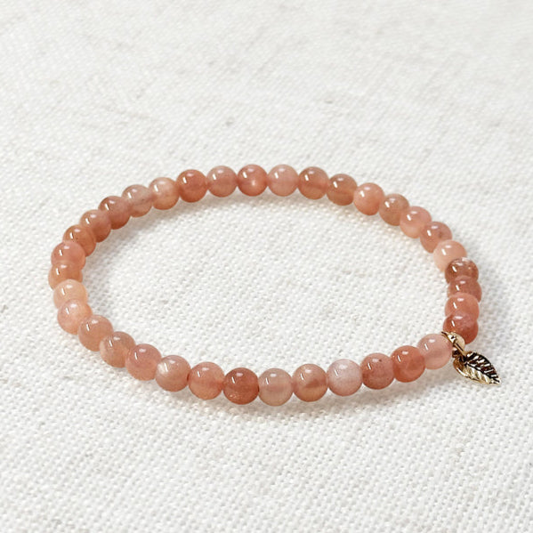 Sunstone bracelet with golden leaf charm, 4mm sparkling peach beads