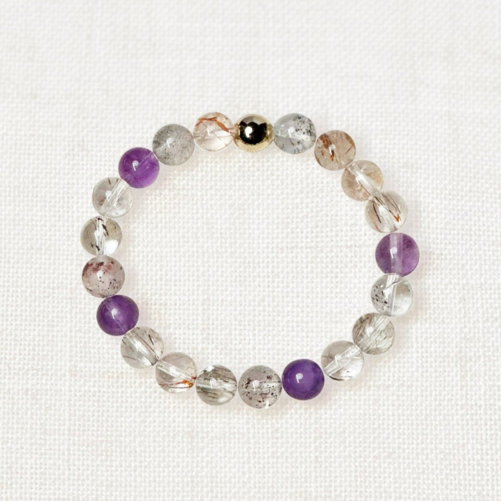 High-quality Super Seven bracelet with 8mm beads and golden bead charm
