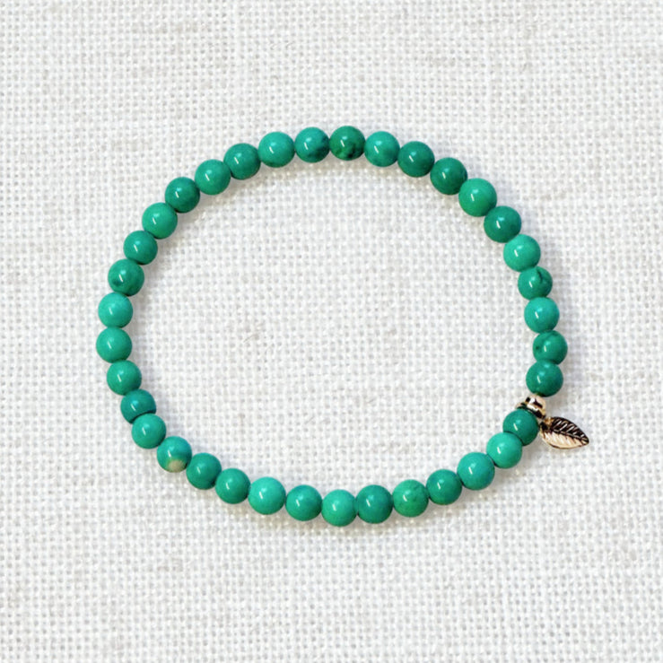 Minimalist turquoise bracelet with soft tones and gold charm