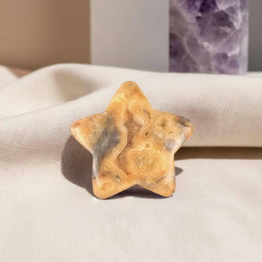 Polished Yellow Lace Agate crystal worry stone in a star shape, promoting optimism, self-belief, and relaxation.