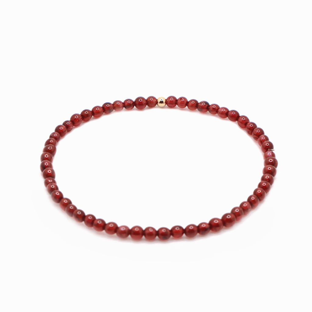 Close-up of garnet crystal bracelet for passion and emotional strength