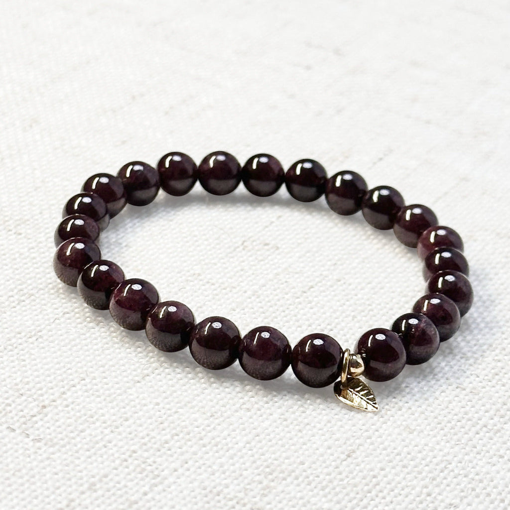 Deep red garnet bracelet with 6mm beads and golden leaf charm