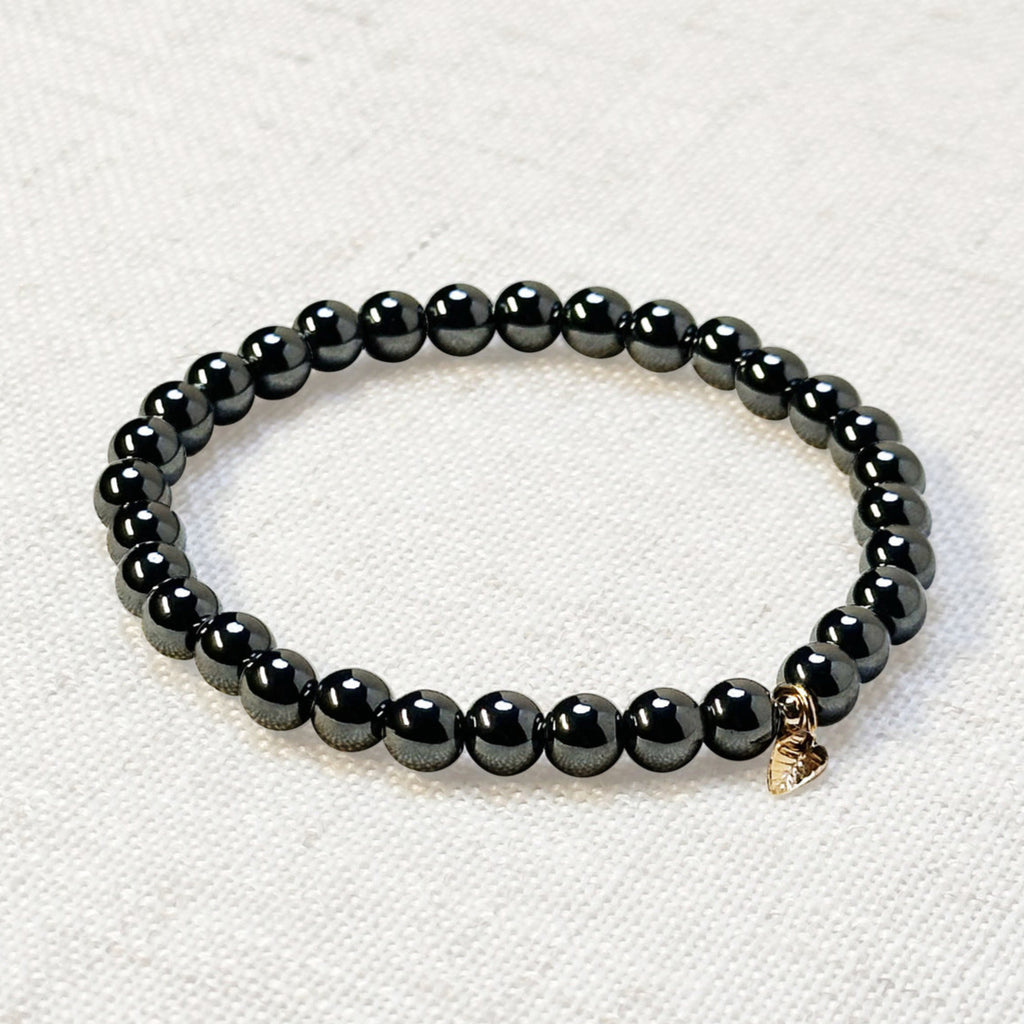 Natural hematite crystal bracelet styled on soft neutral background