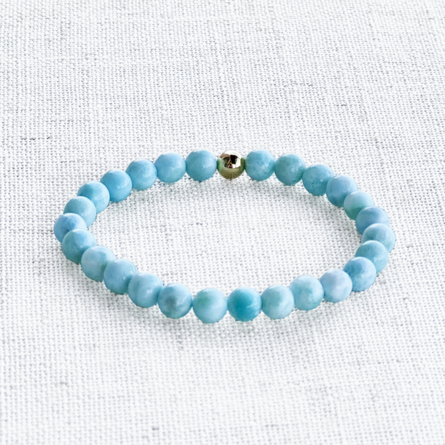 Elegant larimar bracelet styled with golden accents and neutral tones