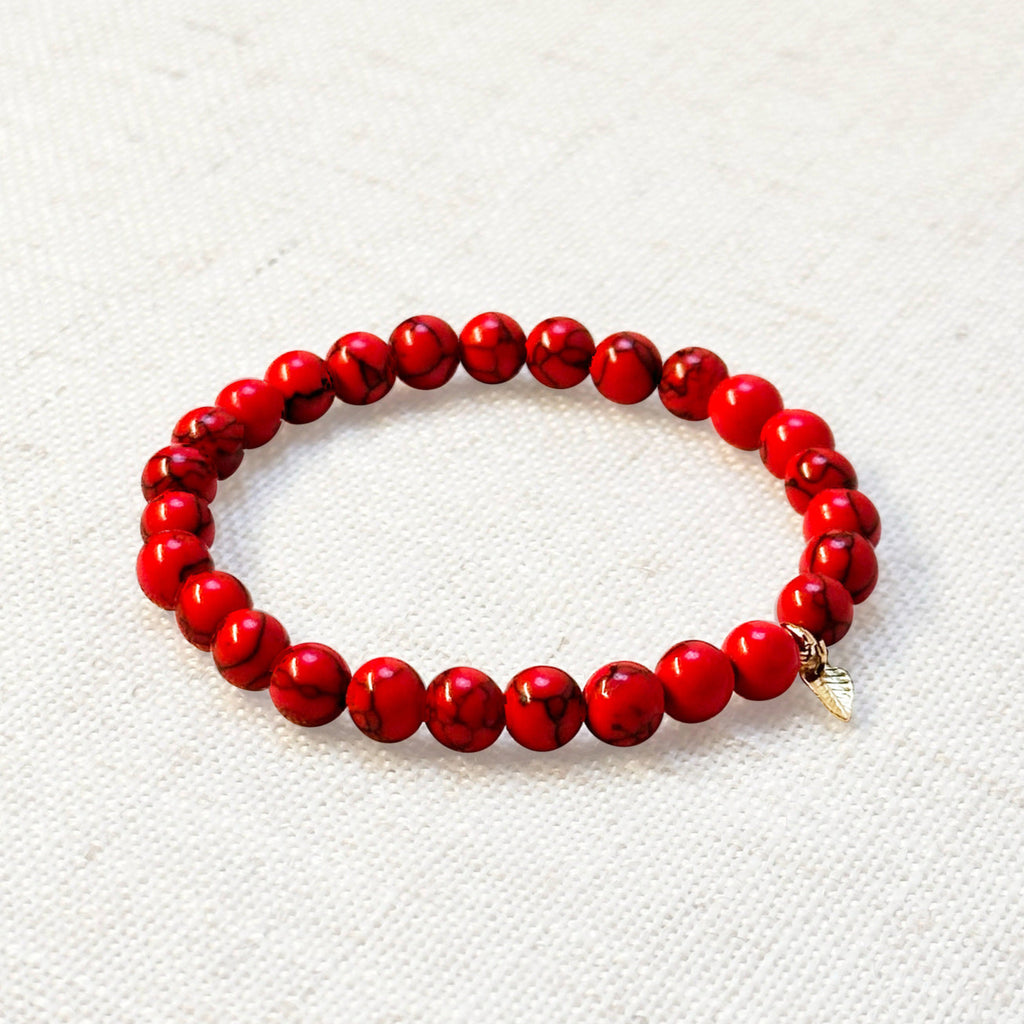 Synthetic red turquoise bracelet with golden leaf charm – 6mm beads