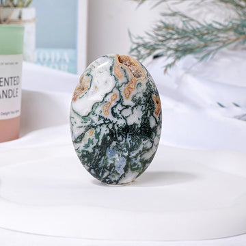 Polished moss agate palm stone showcasing moss agate properties for calm, healing, and focus.