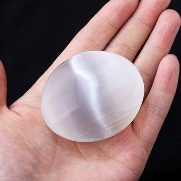 White selenite palm stone for calm, clarity, and spiritual healing. Perfect crystal gift.